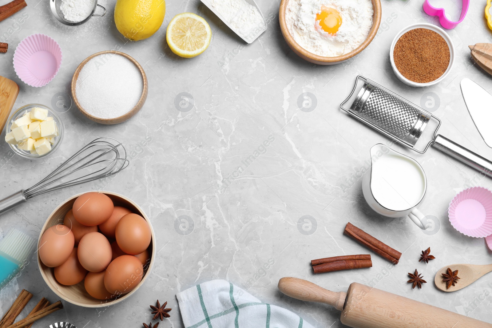 Photo of Frame of cooking utensils and ingredients on light marble table, flat lay. Space for text