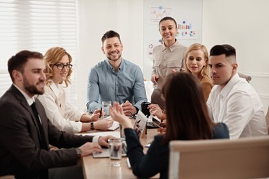 Photo of Businesspeople having meeting in office. Management consulting