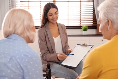 Female notary working with mature couple in office