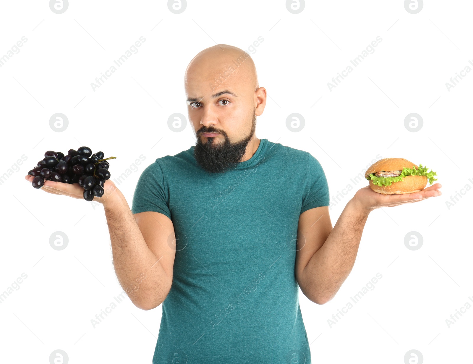 Photo of Overweight man with hamburger and grapes on white background