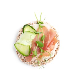 Photo of Crunchy buckwheat cakes with cream cheese, prosciutto and cucumber slice isolated on white, top view