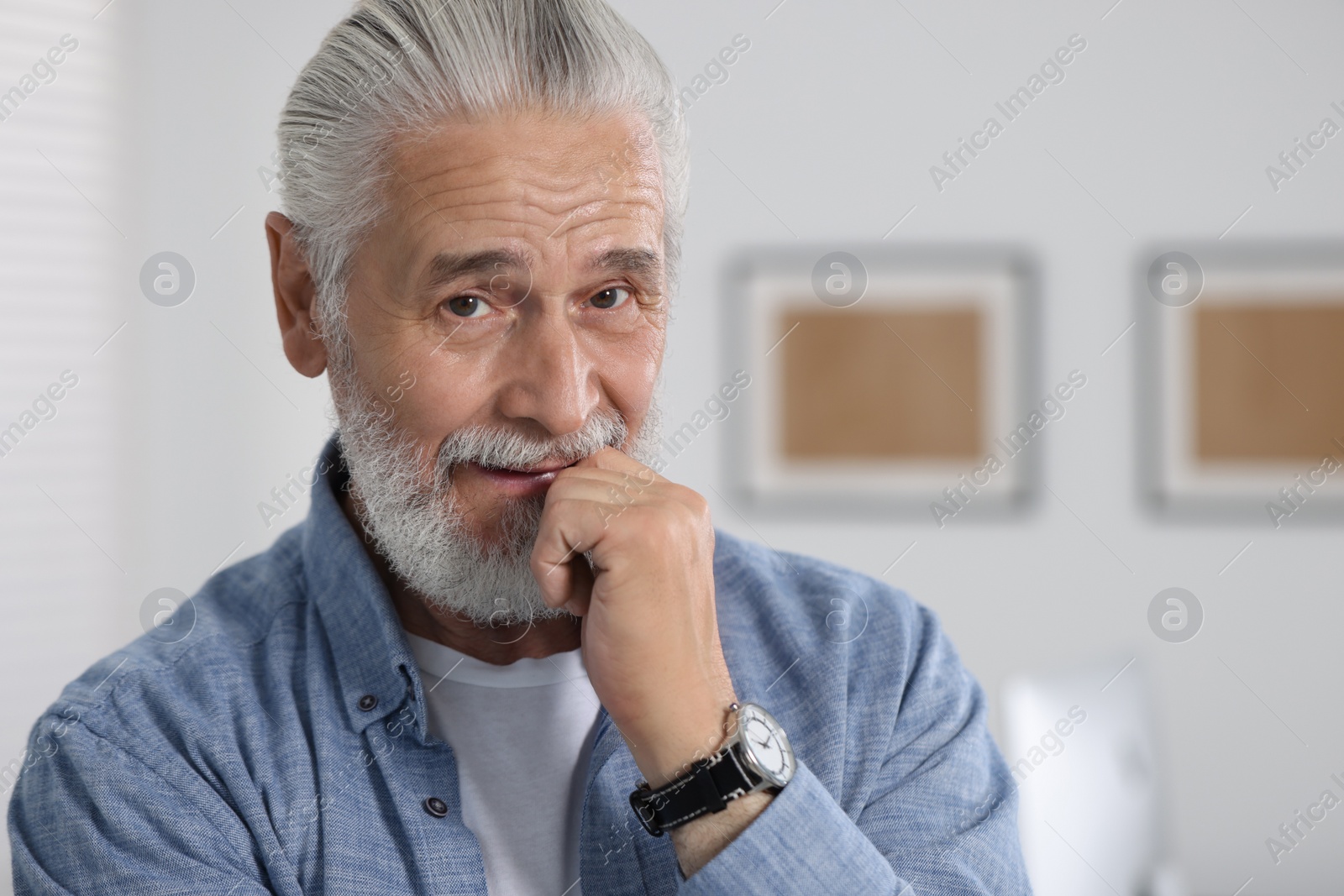 Photo of Portrait of handsome senior man in office. Space for text