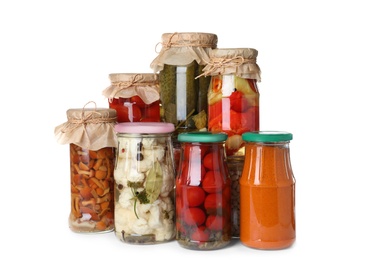 Photo of Different jars with pickled vegetables on white background