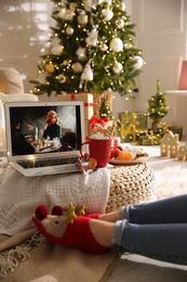 Photo of MYKOLAIV, UKRAINE - DECEMBER 25, 2020: Woman watching The Queen's Gambit series on laptop at home, closeup. Cozy winter holidays atmosphere