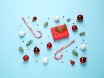 Flat lay composition with Christmas decorations on light blue background