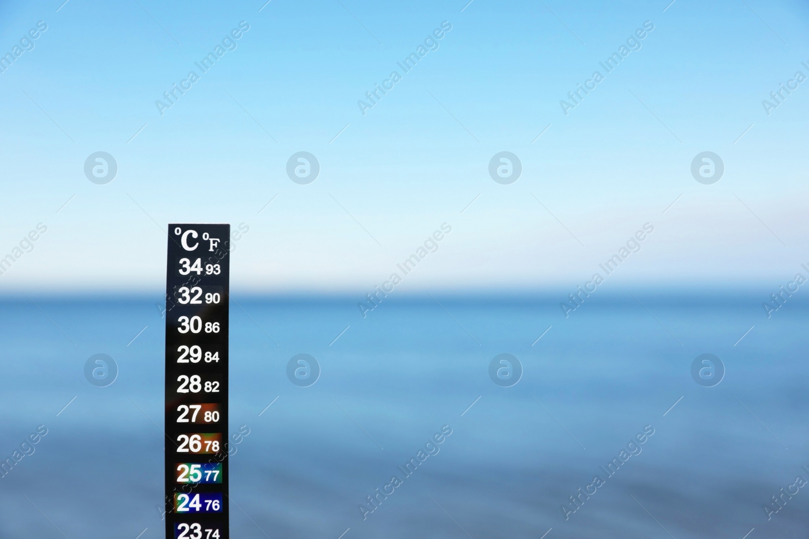 Photo of Weather thermometer at seaside, space for text