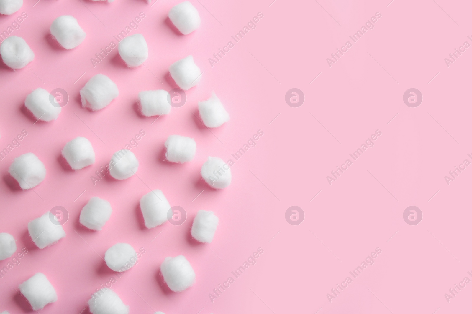 Photo of Flat lay composition with cotton balls and space for text on pink background