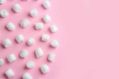 Flat lay composition with cotton balls and space for text on pink background