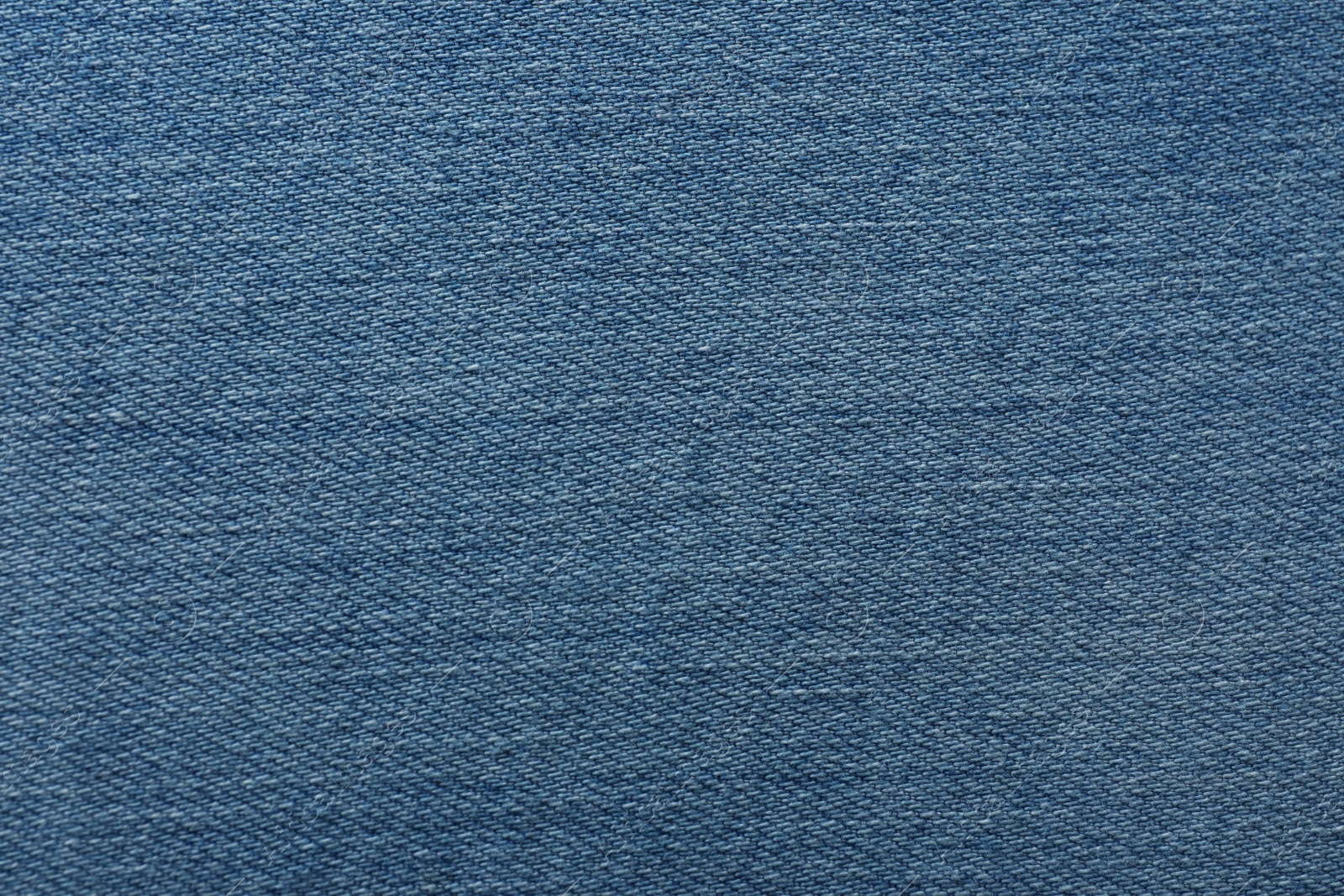 Photo of Texture of blue jeans as background, closeup