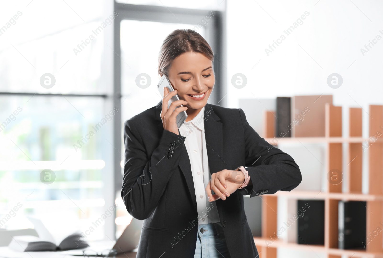 Photo of Female business trainer talking on phone in office