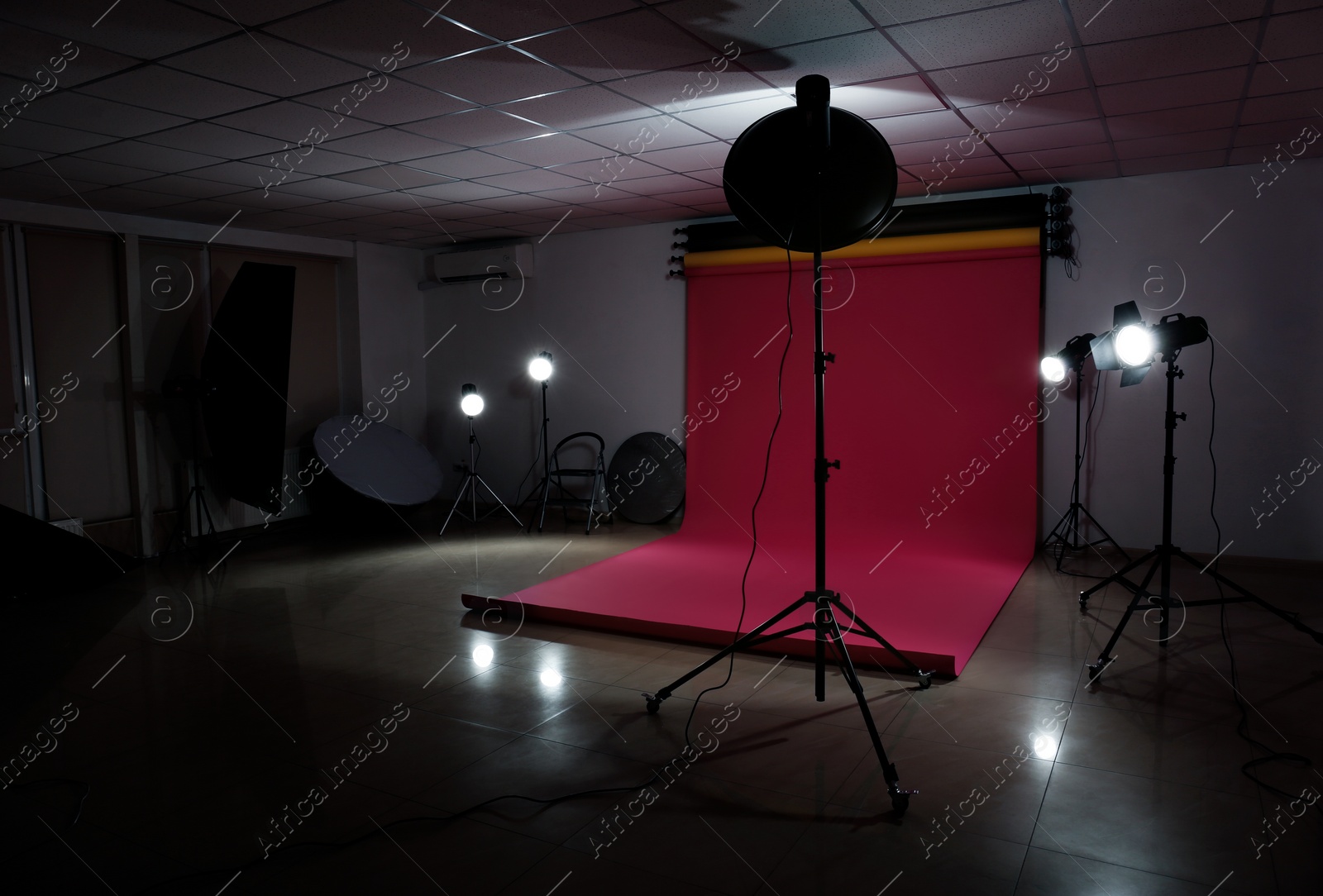 Photo of Interior of modern photo studio with professional lighting equipment