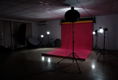 Interior of modern photo studio with professional lighting equipment