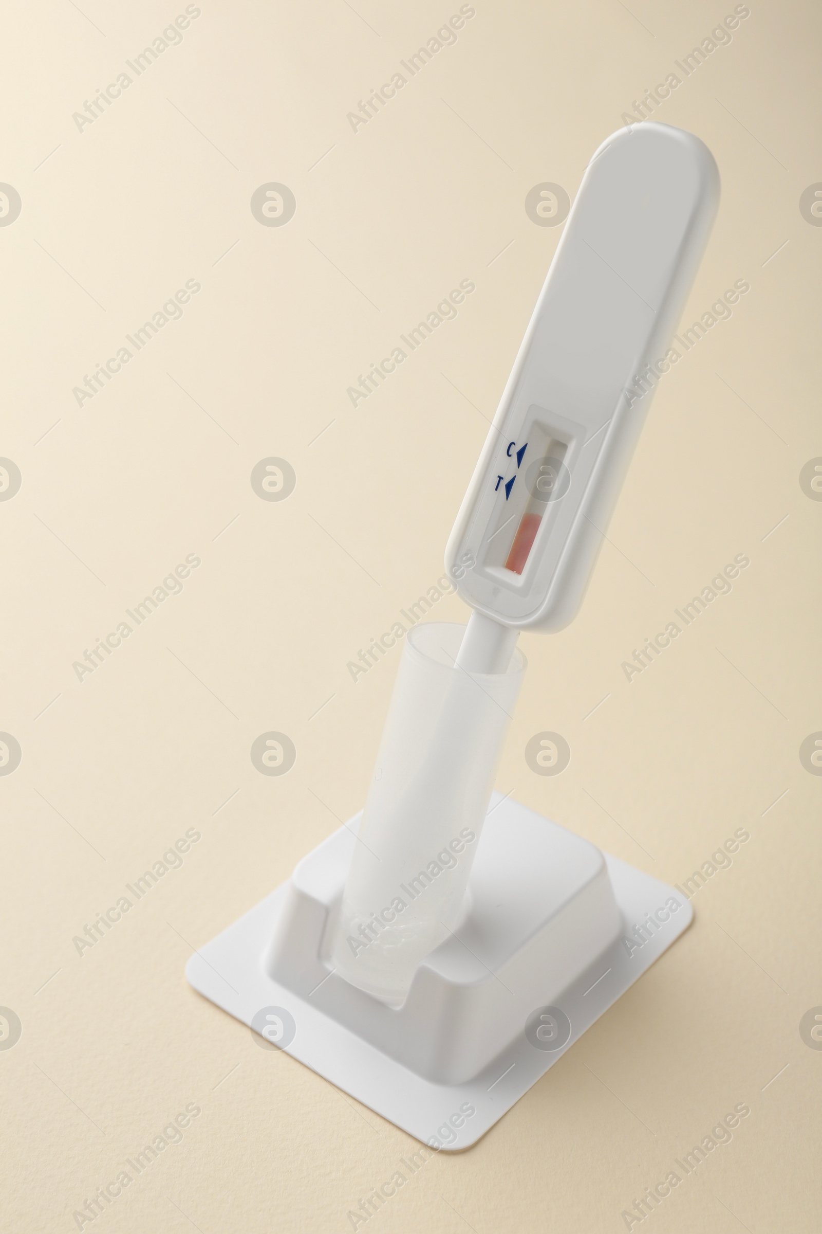 Photo of One disposable express test on beige background