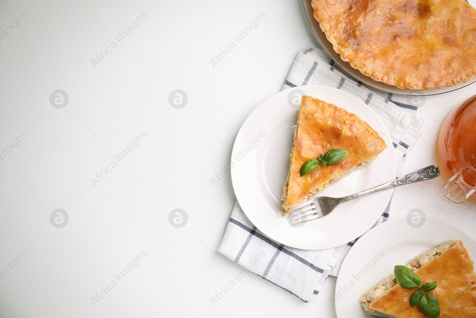 Photo of Delicious pie with meat and basil on white table, flat lay. Space for text