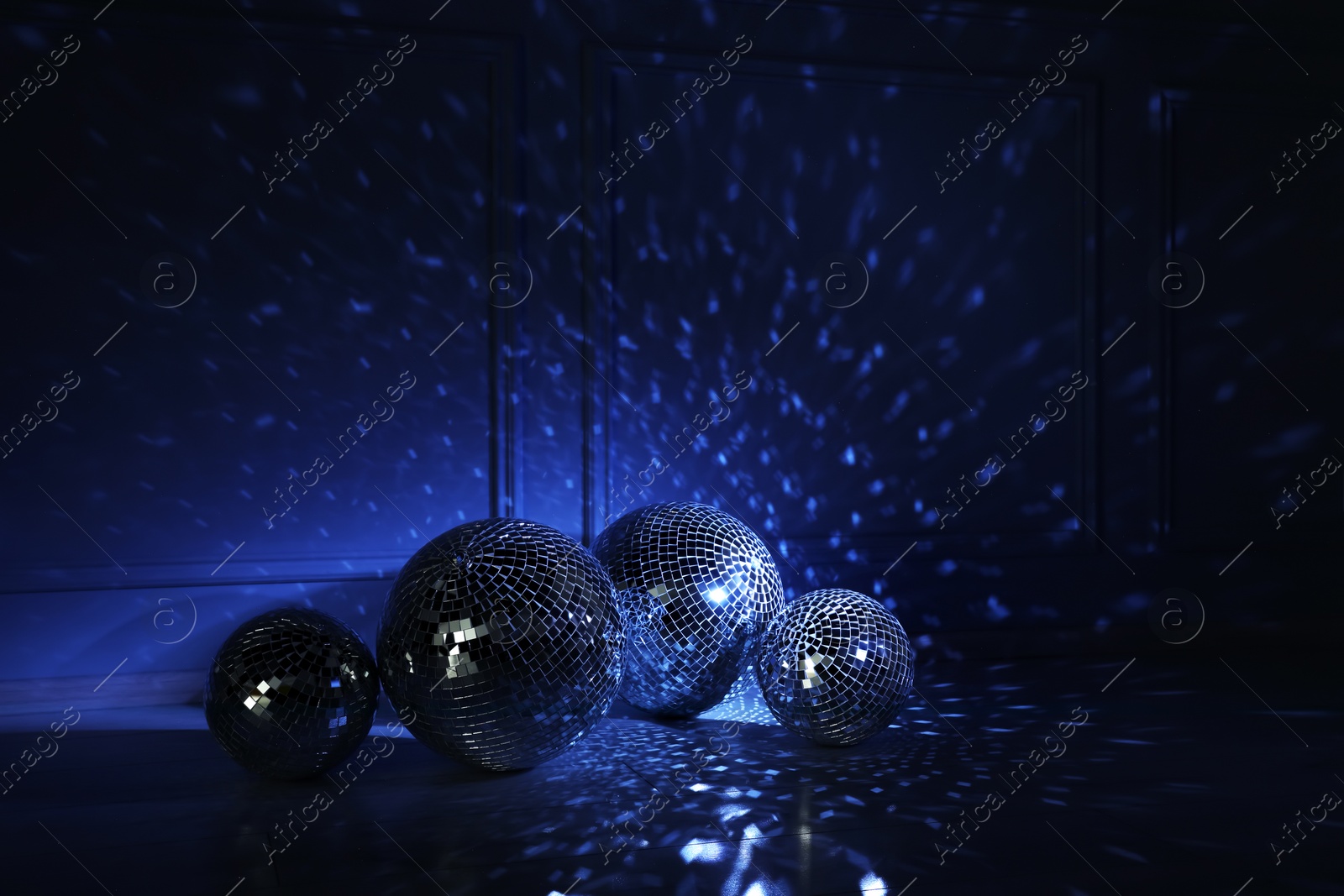 Photo of Shiny disco balls indoors, toned in dark blue