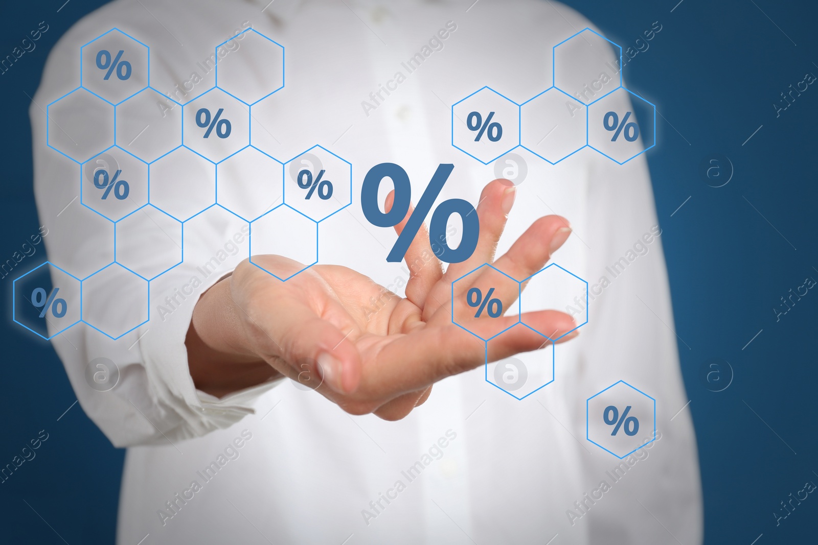 Image of Woman showing virtual percent sign on blue background, closeup. Discount concept