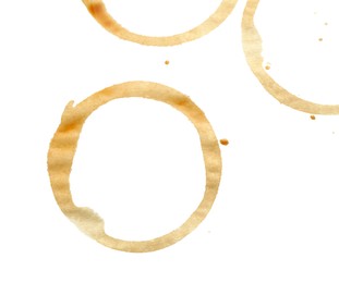 Photo of Coffee cup stains isolated on white, top view