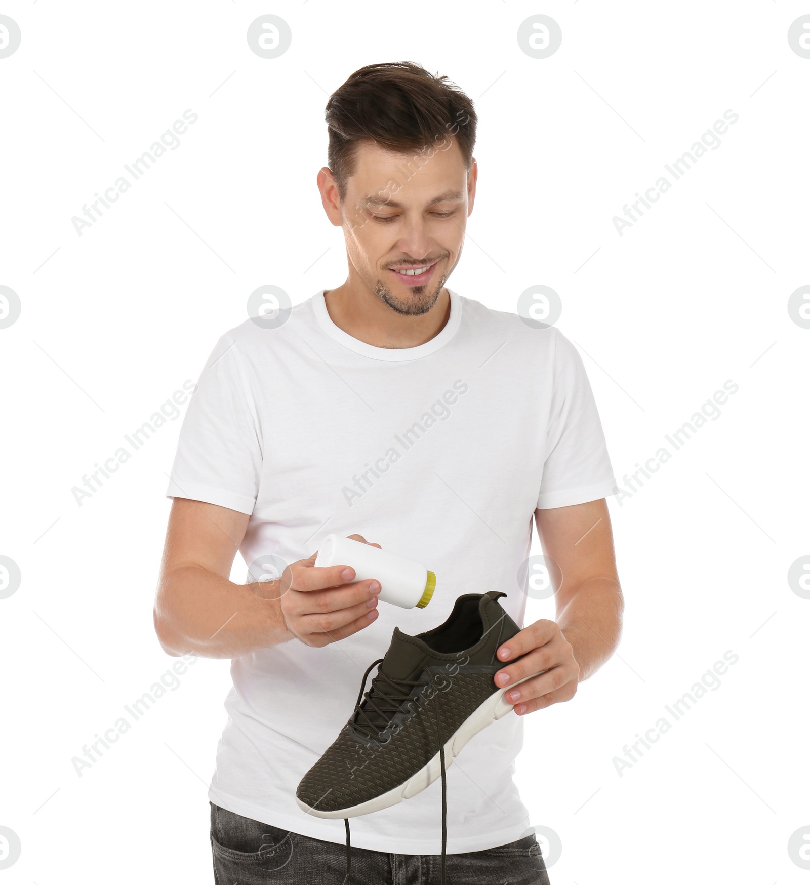 Photo of Man putting powder freshener into shoe on white background