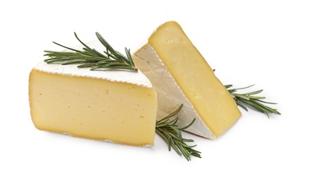 Photo of Pieces of tasty camembert cheese and rosemary isolated on white