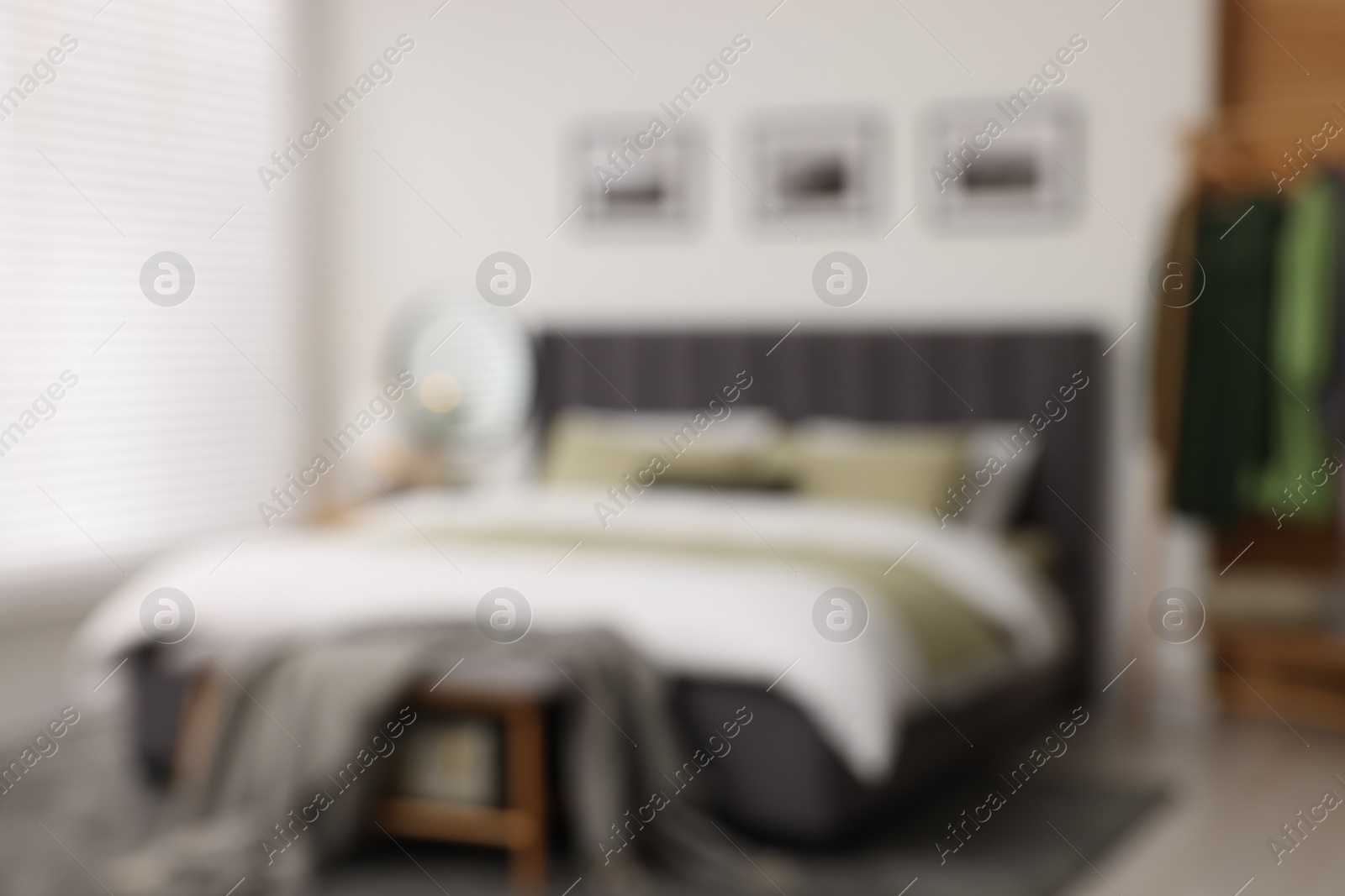 Photo of Blurred view of room with comfortable bed