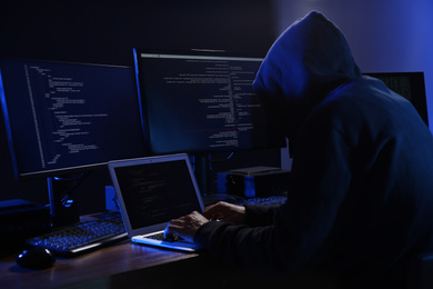 Photo of Hacker with computers in dark room. Cyber crime