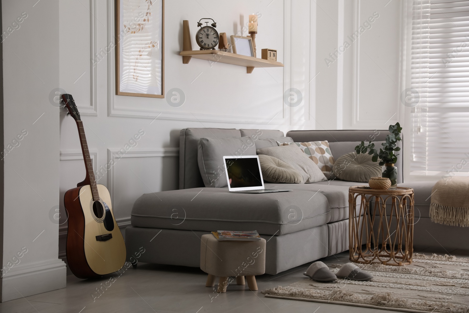 Photo of Living room with comfortable grey sofa and stylish interior elements