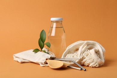Photo of Composition with eco friendly products on orange background. Conscious consumption