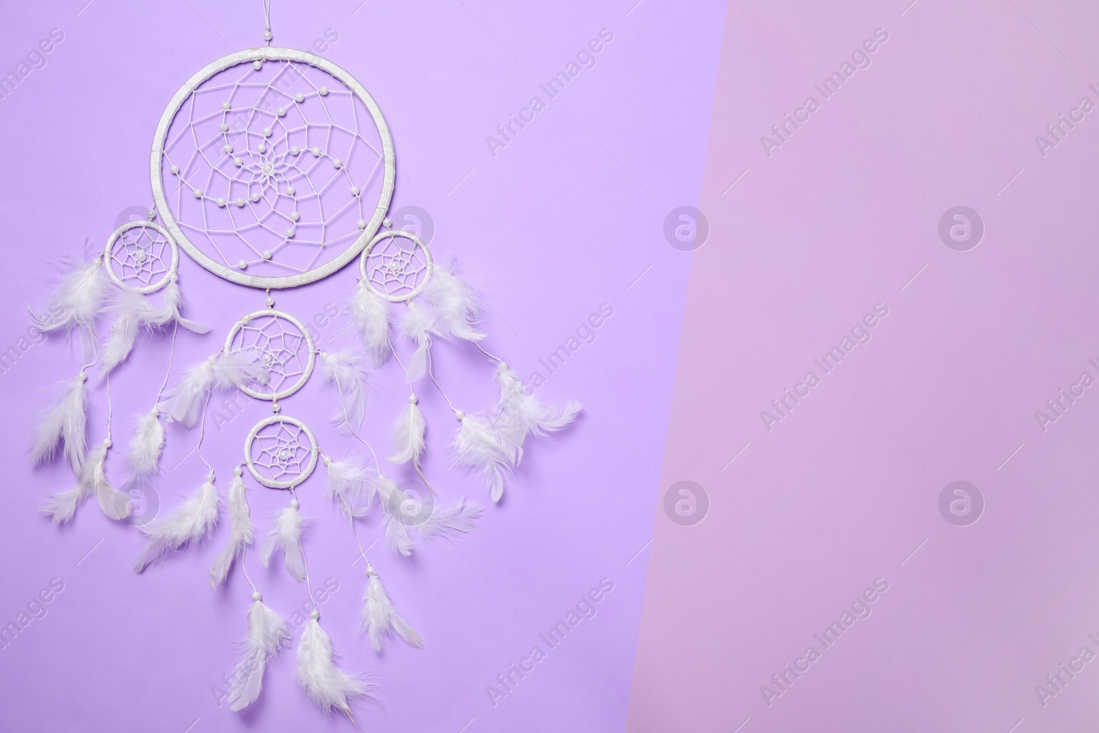 Photo of Beautiful dream catcher on color background, top view. Space for text