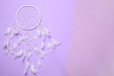 Photo of Beautiful dream catcher on color background, top view. Space for text