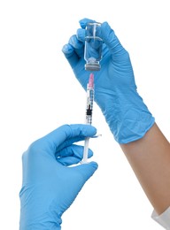 Photo of Doctor filling syringe with medication from glass vial on white background, closeup