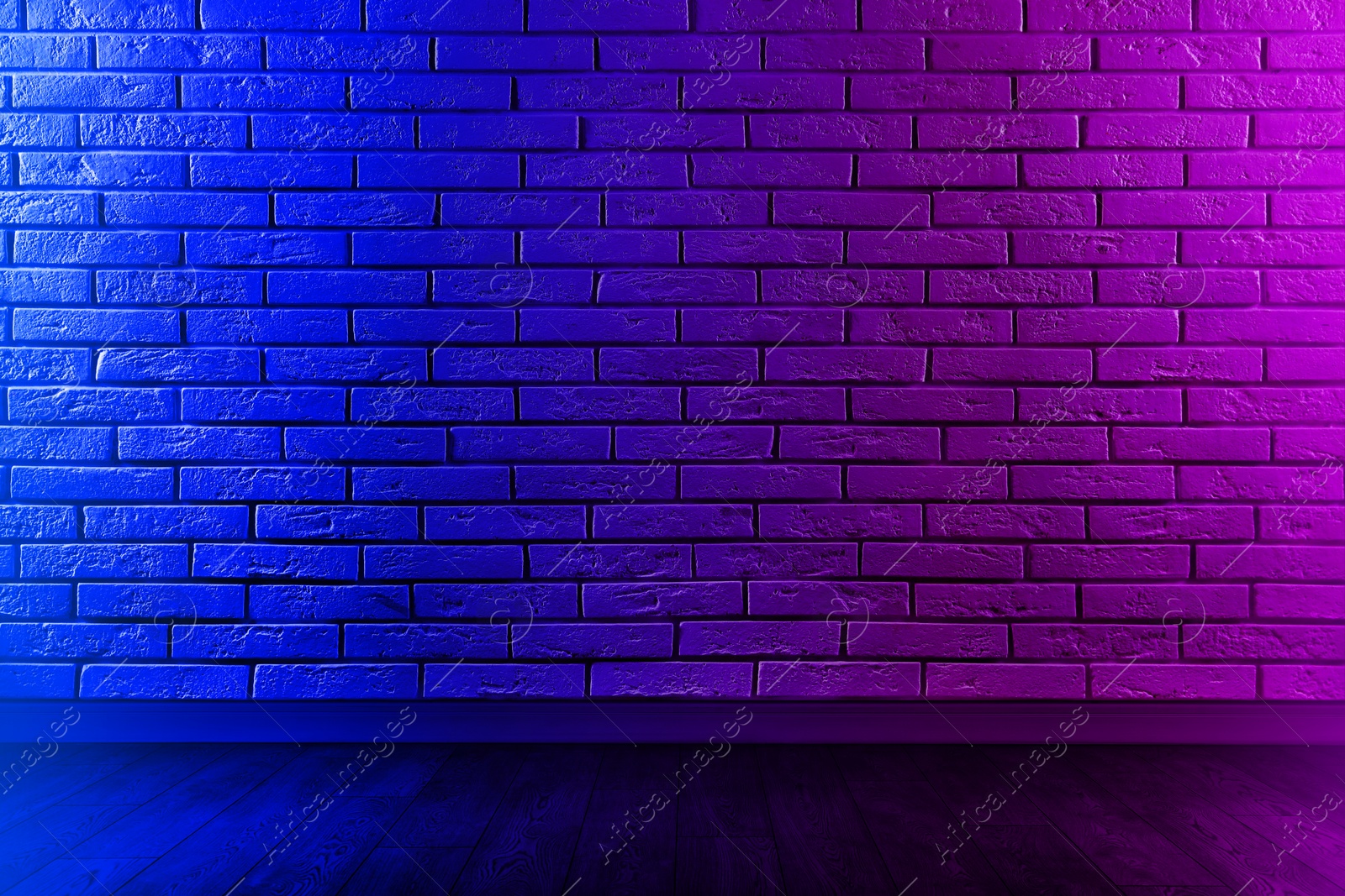 Image of Room with brick wall and wooden floor in neon lights