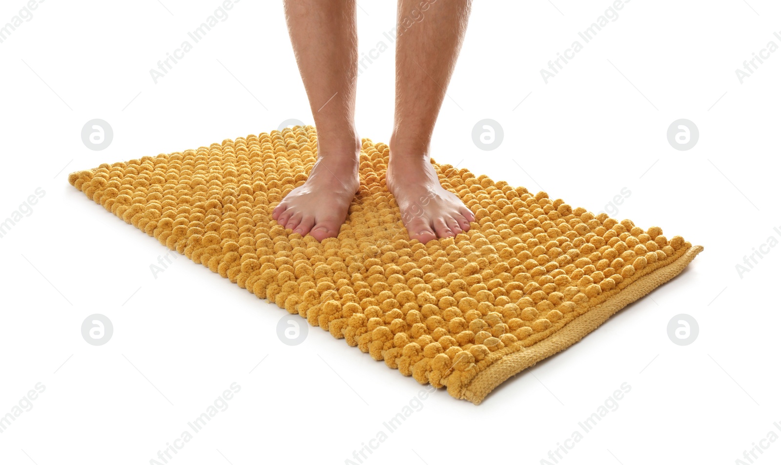 Photo of Man standing on soft orange bath mat against white background, closeup