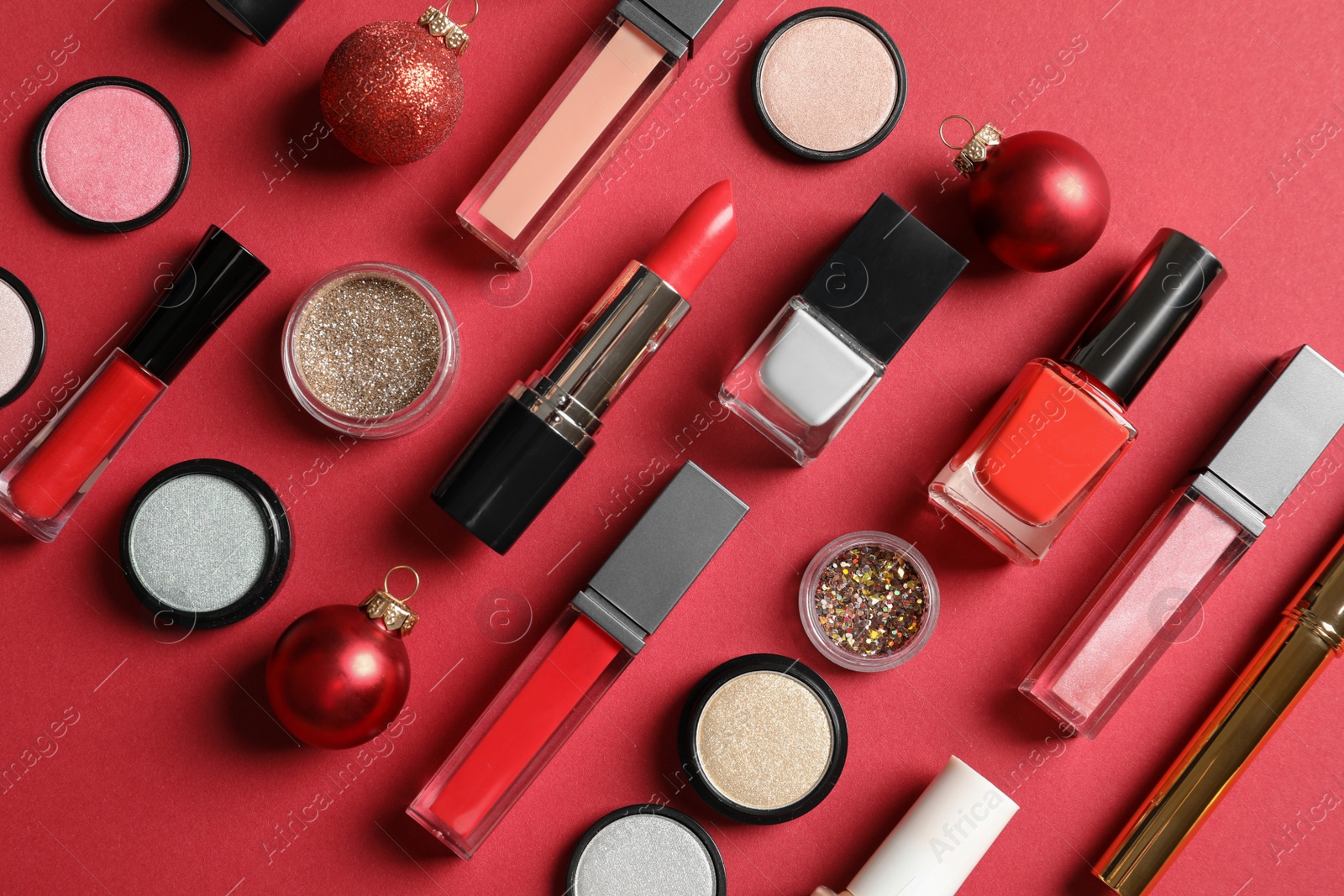 Photo of Flat lay composition with makeup products and Christmas decor on color background