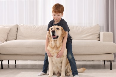 Photo of Cute child with his Labrador Retriever at home. Adorable pet