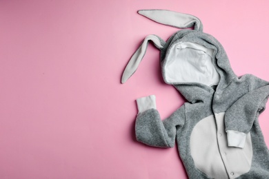 Photo of Adorable bodysuit with bunny ears and space for text on color background, flat lay. Baby accessories