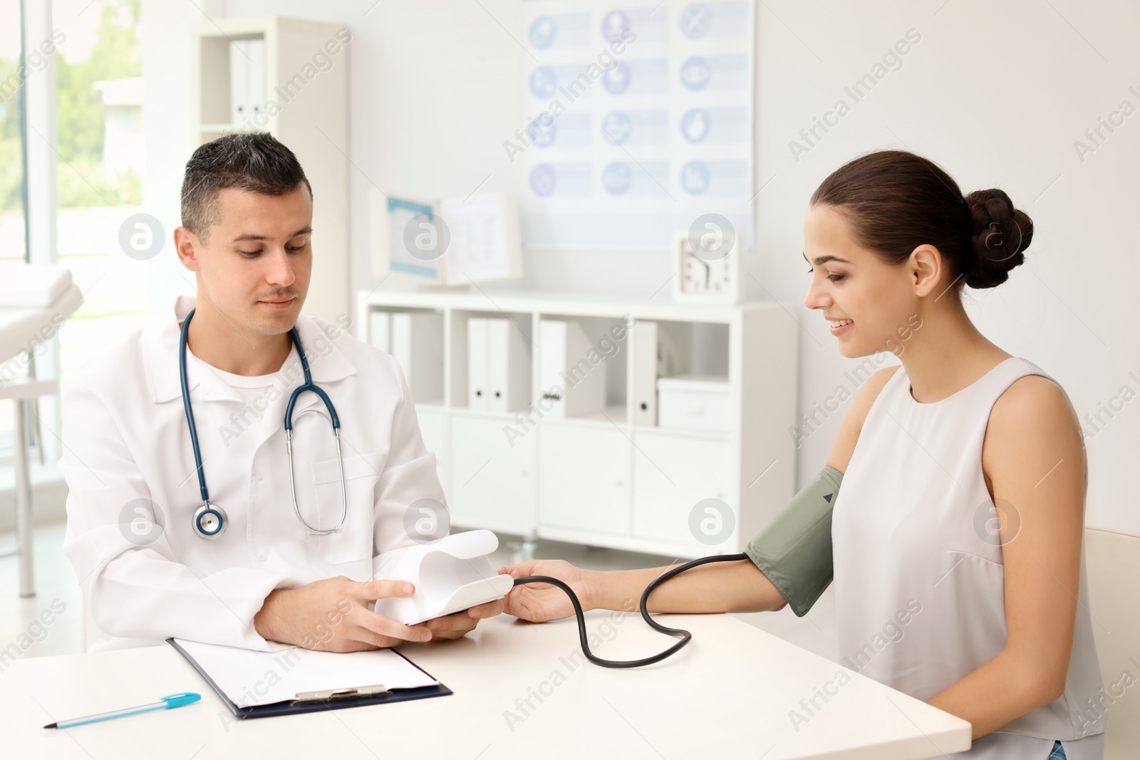 Photo of Doctor checking patient's blood pressure in hospital