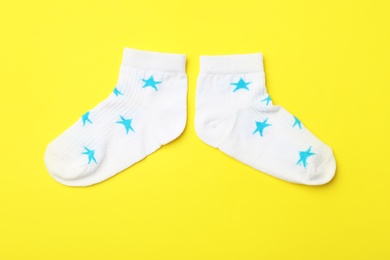 Cute child socks on color background, flat lay