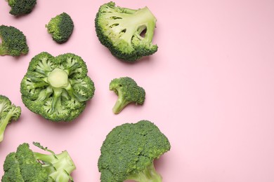 Photo of Fresh broccoli on pink background, flat lay. Space for text