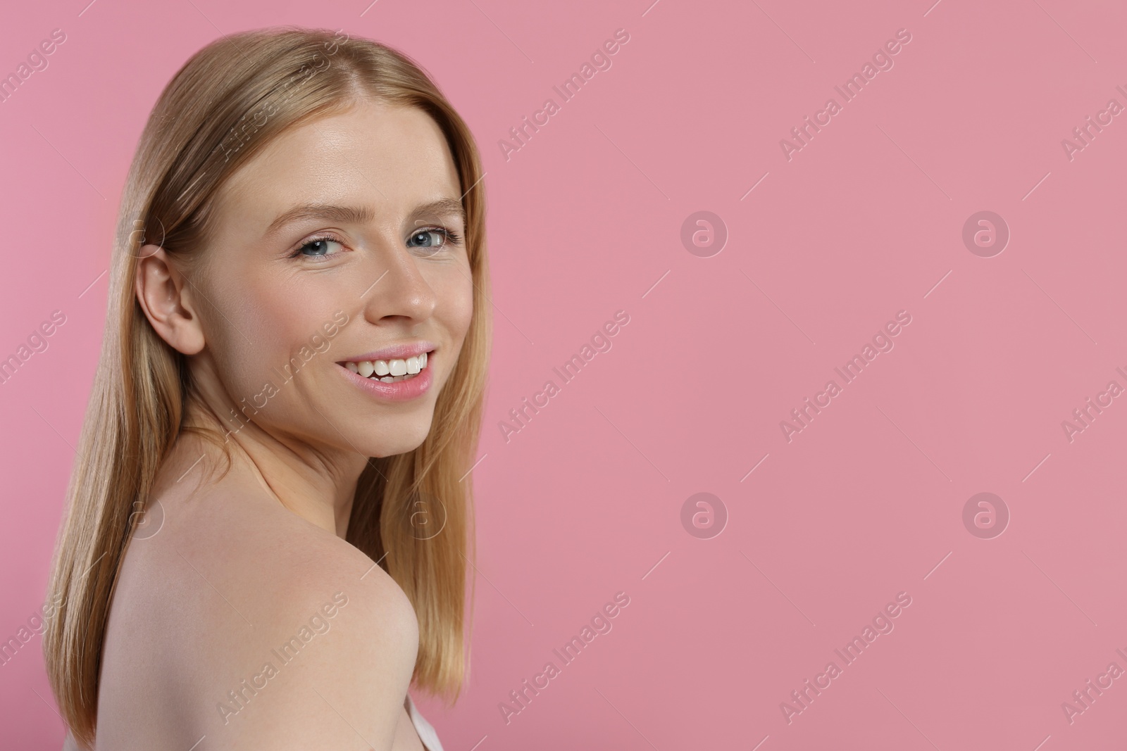 Photo of Portrait of beautiful young woman on pink background. Space for text