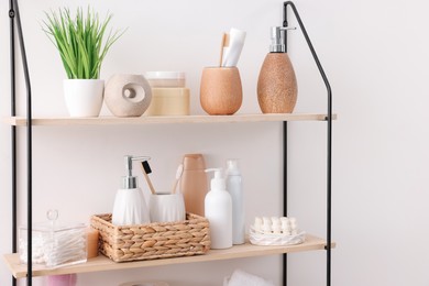 Photo of Different bath accessories, personal care products and artificial plant indoors, space for text