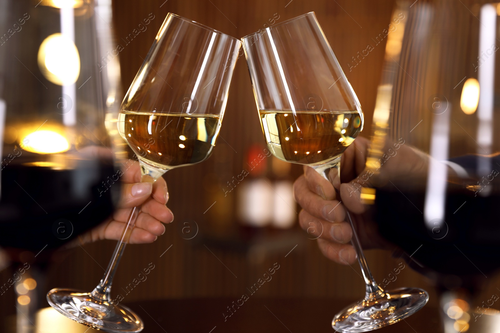 Photo of People with glasses of wine on blurred background, closeup