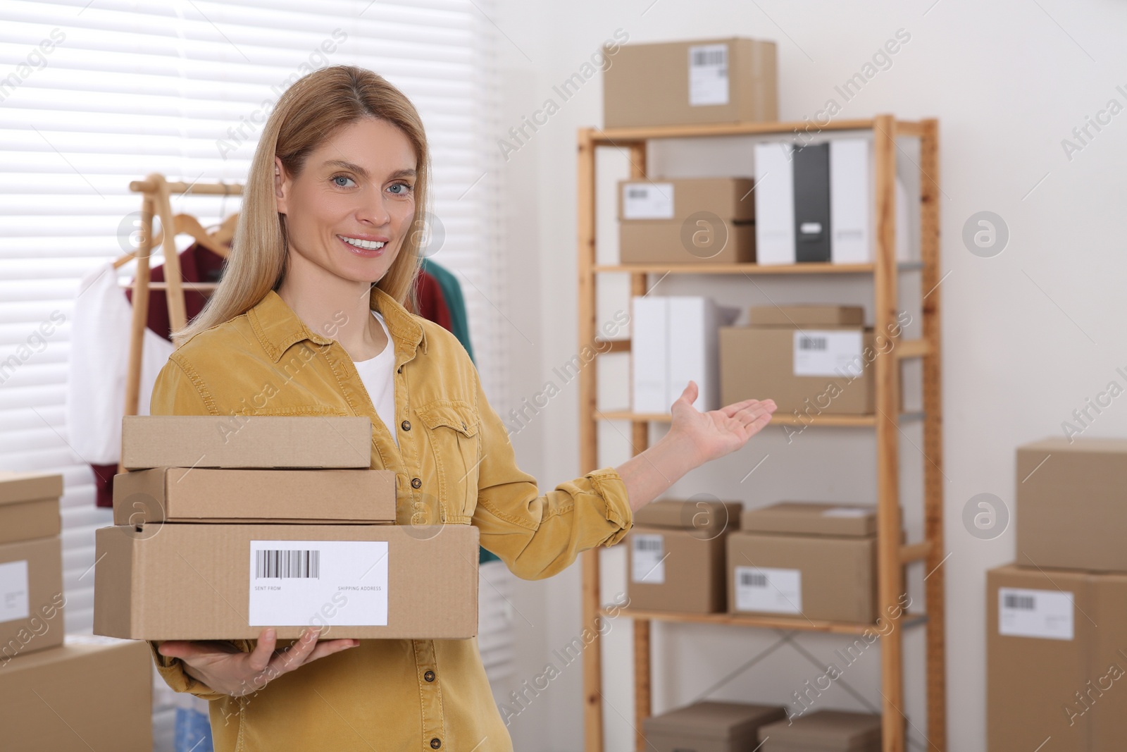 Photo of Seller with parcels in office. Online store