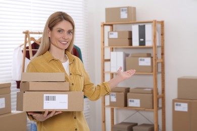 Photo of Seller with parcels in office. Online store