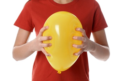 Woman squeezing yellow balloon on white background, closeup