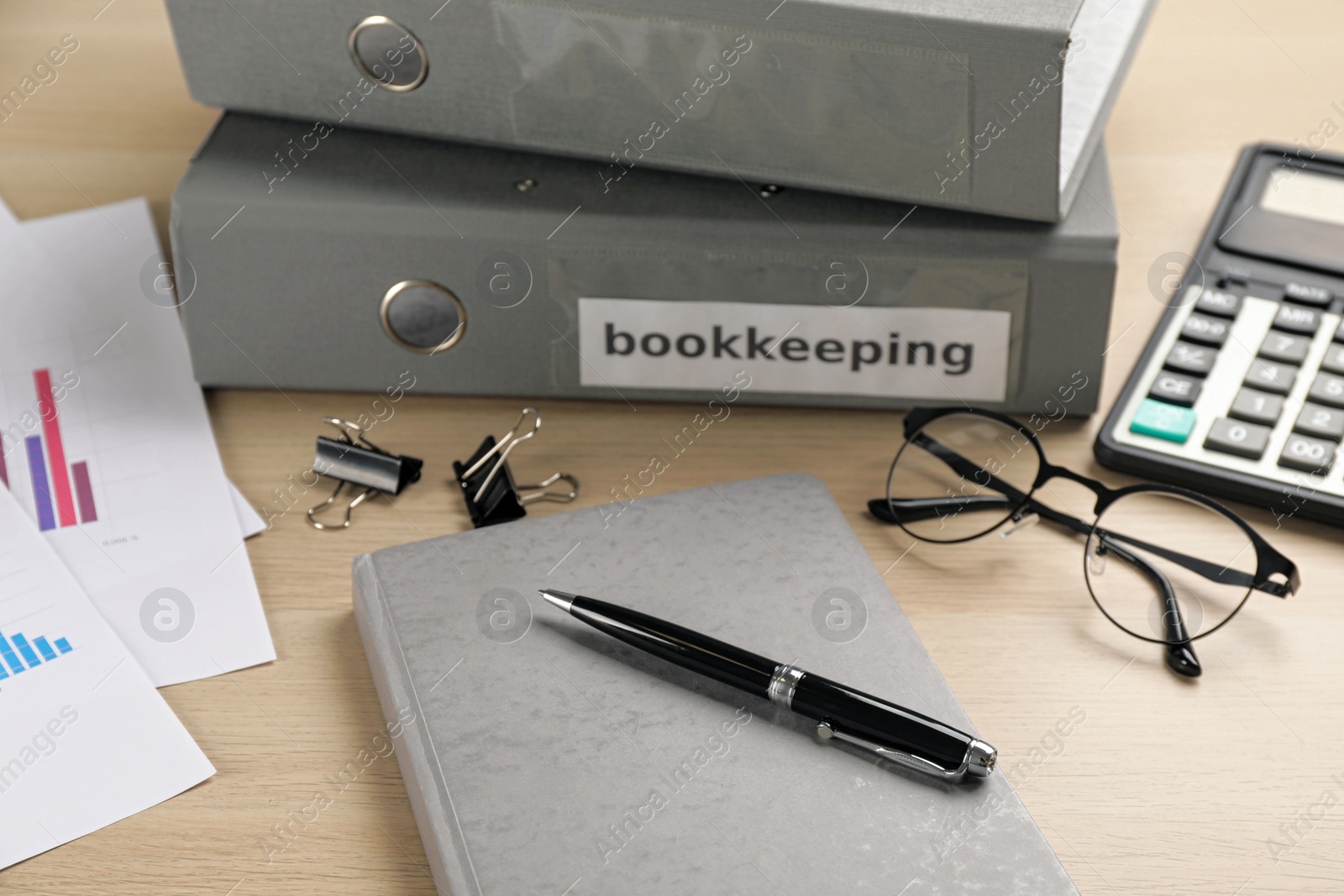 Photo of Bookkeeper's workplace with folders and documents on table