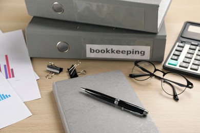 Bookkeeper's workplace with folders and documents on table