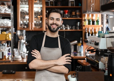 Photo of Portrait of smiling barista in coffee shop