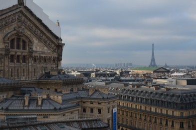 Paris, France - December 10, 2022: Panoramic view of city with Eiffel Tower on cloudy day
