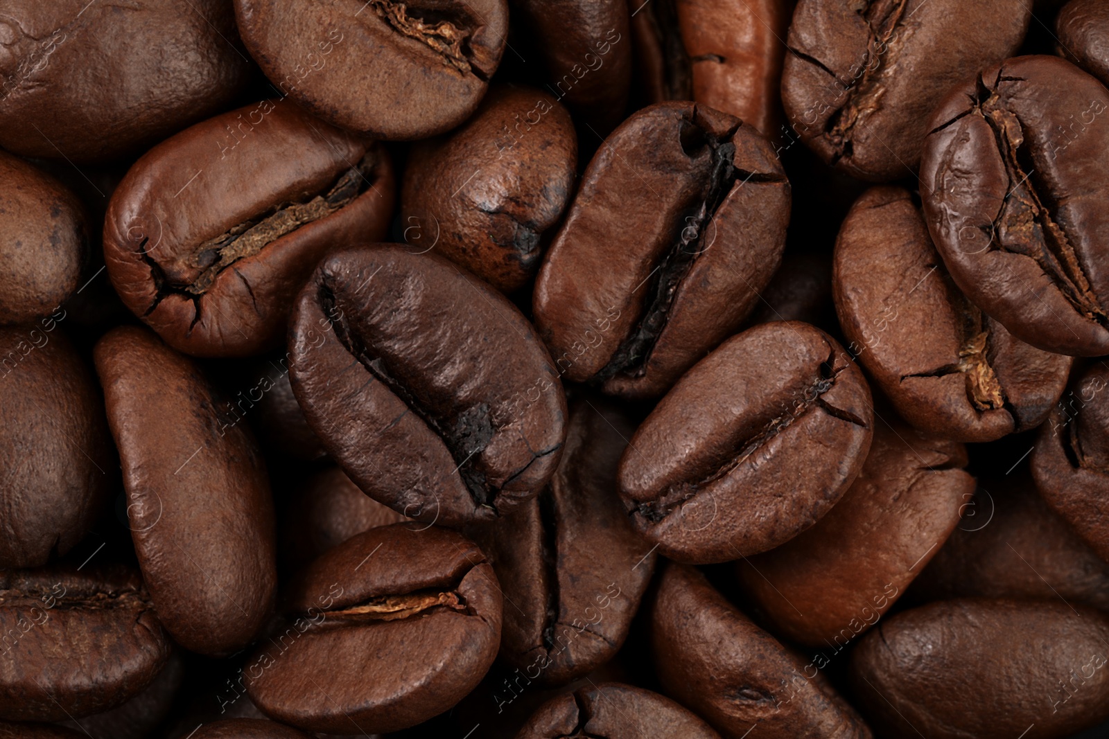 Photo of Aromatic roasted coffee beans as background, top view