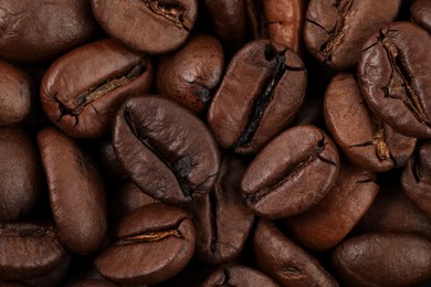 Photo of Aromatic roasted coffee beans as background, top view